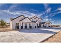 Row of two-story homes with dark trim, desert landscaping, and concrete driveways at 384 E Erin St # 3, Pahrump, NV 89048