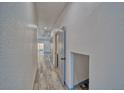 Hallway with wood-look flooring and white walls leading to an open space at 384 E Erin St # 3, Pahrump, NV 89048
