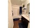 Cozy bathroom with shower-tub combo and dark wood cabinets offer a comfortable and functional space at 384 Gracious Way, Henderson, NV 89011