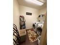 Efficient laundry room with modern washer and dryer, shelving, and stylish decor at 384 Gracious Way, Henderson, NV 89011