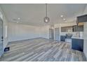 Bright and spacious living room and open kitchen with modern finishes and stylish pendant lighting at 388 E Erin St # 4, Pahrump, NV 89048