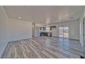 Inviting living room flows to the kitchen featuring gray cabinets and abundant natural light at 388 E Erin St # 4, Pahrump, NV 89048