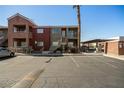 Apartment buildings exterior showing assigned parking spaces, palm trees and stairways at 4730 E Craig Rd # 2190, Las Vegas, NV 89115