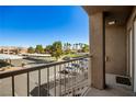 Balcony view showcases community parking, landscaping and building's exterior features under a blue sky at 4730 E Craig Rd # 2190, Las Vegas, NV 89115