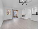 Spacious living room with a fireplace and patio access, showcasing sleek gray floors at 5155 W Tropicana Ave # 1052, Las Vegas, NV 89103