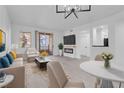 Inviting living room featuring a fireplace, patio access, and sleek gray floors at 5155 W Tropicana Ave # 1052, Las Vegas, NV 89103