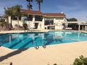 Community pool featuring a large, sparkling pool with lounge chairs and shaded areas at 5716 Ridgeline Ave, Las Vegas, NV 89107