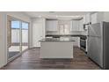 Modern kitchen featuring stainless steel appliances, central island, and sliding glass door at 6282 Blood Lily Ave, Las Vegas, NV 89122