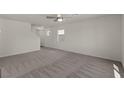 Bright living room with neutral carpet, ceiling fan, and ample natural light at 6282 Blood Lily Ave, Las Vegas, NV 89122