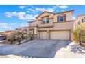 Inviting two-story home showcasing a two-car garage, desert landscaping, and a well-maintained front yard at 63 Crescent Palm Ct, Henderson, NV 89002
