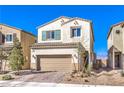 Charming two-story home with a well-manicured lawn and an attached two-car garage with a brick paved drive at 6637 Rockhouse St, North Las Vegas, NV 89086