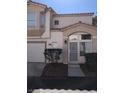 Inviting two-story home with stucco siding, a covered entry, attached garage and well-maintained landscaping at 6965 Coral Rock Dr, Las Vegas, NV 89108