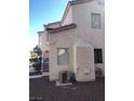 View of the back of the home with neutral colors and low maintenance desert landscaping at 6965 Coral Rock Dr, Las Vegas, NV 89108