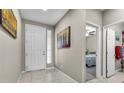 Bright and airy foyer featuring tiled floors, neutral walls, and decorative artwork at 71 Gosia Grove Ave, North Las Vegas, NV 89031