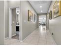 Hallway with tiled floors and neutral walls leading to other rooms at 71 Gosia Grove Ave, North Las Vegas, NV 89031