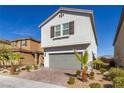 Two-story home featuring desert landscaping and a two-car garage at 8446 Vacarez Dr, Las Vegas, NV 89149