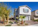 Two-story home featuring desert landscaping and a two-car garage at 8446 Vacarez Dr, Las Vegas, NV 89149