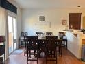 Dining room with dark wood table, chairs, and access to the backyard at 9299 Adamshurst Ave, Las Vegas, NV 89148