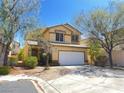 Inviting two-story house with a two-car garage and mature trees in the front yard at 9299 Adamshurst Ave, Las Vegas, NV 89148