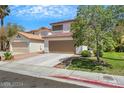 Attractive two-story home with a well-kept lawn and a convenient two-car garage at 10218 Maltese Cross Ct, Las Vegas, NV 89183