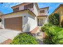 Inviting two-story home with a two-car garage and lush landscaping at 10218 Maltese Cross Ct, Las Vegas, NV 89183