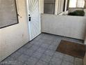 Tiled front patio with a decorative metal security door at 1105 Sulphur Springs Ln # 102, Las Vegas, NV 89128