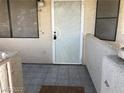 Tiled front patio with a decorative metal security door at 1105 Sulphur Springs Ln # 102, Las Vegas, NV 89128