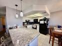 Bright kitchen featuring granite countertops, modern appliances, and pendant lighting over the breakfast bar at 1105 Sulphur Springs Ln # 202, Las Vegas, NV 89128