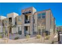 Contemporary townhome with a stone exterior, a quaint balcony, and desert-friendly landscaping at 1135 Tektite Ave, Henderson, NV 89011