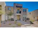 Stylish townhome boasting stone accents, private balcony, and low-maintenance landscaping at 1135 Tektite Ave, Henderson, NV 89011