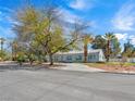 Classic ranch-style home with mature trees, a wide driveway, and a serene residential setting at 1139 5Th Pl, Las Vegas, NV 89104
