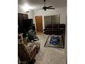 Living room with large window, carpet, ceiling fan, and leather sofas at 1407 Santa Margarita St # A, Las Vegas, NV 89146