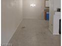 Open concept living room with durable tile flooring, cozy lighting, and a glimpse of the kitchen area at 1608 N Torrey Pines Dr # 103, Las Vegas, NV 89108