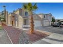 Attractive home boasting well-maintained landscaping, a two-car garage, and a charming desert aesthetic at 1821 Cedar Bluffs Way, Las Vegas, NV 89128