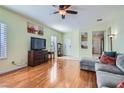 Spacious living area featuring a ceiling fan, wood floors, neutral walls, and ample natural light at 2152 Mountain City St, Henderson, NV 89052