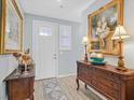 Elegant entryway featuring a wooden console table adorned with lamps and decorative items at 2587 Tolmezzo St, Henderson, NV 89044