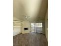 Cozy living room featuring a fireplace, shelving, and sliding glass doors at 2995 E Sunset Rd # 237, Las Vegas, NV 89120