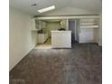Open-concept living room with modern kitchen and plush carpeting at 2995 E Sunset Rd # 237, Las Vegas, NV 89120