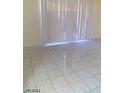 Living room featuring white tile flooring and vertical blinds at 3435 Villa Knolls South Dr, Las Vegas, NV 89120