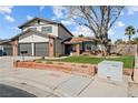 Charming two-story home featuring a well-manicured lawn, two-car garage, and mature trees at 3730 Grandview Pl, Las Vegas, NV 89120