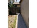 Side yard with partial fence and walkway around the property at 4231 White Sands Ave, Las Vegas, NV 89121