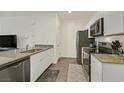 The kitchen features white cabinets, granite countertops, stainless steel appliances, and a view into the living area at 527 Clearsable Ave, Henderson, NV 89044