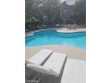 Inviting community pool with lounge chairs and tables, perfect for relaxation and socializing at 555 E Silverado Ranch Blvd # 1123, Las Vegas, NV 89183