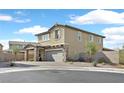 A charming two-story home with a stone-accented facade, a two-car garage, and a circular driveway at 625 Honesty Ct, Henderson, NV 89011
