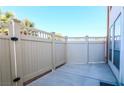 Private outdoor patio area with a light-colored fence and a concrete floor, perfect for outdoor relaxation and enjoyment at 669 Oakmont Ave # 3709, Las Vegas, NV 89109