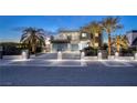 Charming modern home featuring palm trees, sleek lines, and a private gated driveway at 675 Benedict Dr, Las Vegas, NV 89110