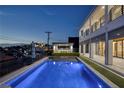 Inviting pool area with a spacious patio, modern pergola, and city views at 675 Benedict Dr, Las Vegas, NV 89110