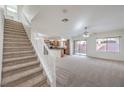 Open concept living room and kitchen with a staircase leading to the second floor at 6856 Pipil St, Las Vegas, NV 89166