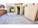 A charming patio area with attractive paver stones and neutral stucco walls at 8216 Chimney Bluffs St, North Las Vegas, NV 89085
