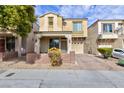 Two story home with stucco and stone exterior, desert landscaping, and an attached one car garage at 9748 Villa Lorena Ave, Las Vegas, NV 89147